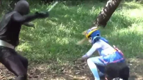 Asian Performers in Costumes Engage in Action Poses