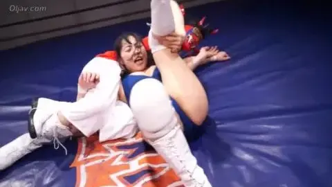 Asian Women Wrestle Blond Man in Ring