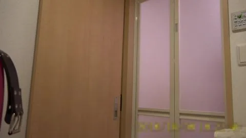 Asian Woman Exposes Breasts in Bedroom