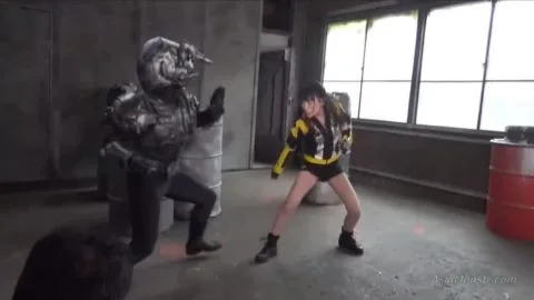 Asian Performers in Costumes Engage in Fighting Poses