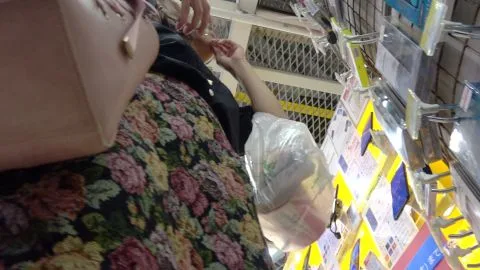 Asian Girl Shopping in Electronics Store