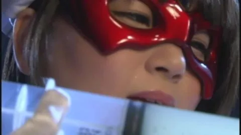 Asian Performer in Red Mask with Syringe