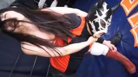 Dark-Haired Women Wrestling in Orange Leotards