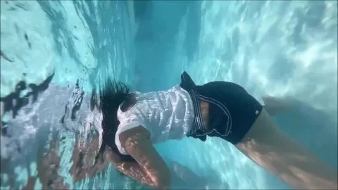 Underwater Pool Scene with Women in Swimwear