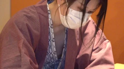 Asian Woman in Robe and Face Mask