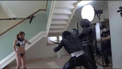 Girl in Bikinis Fights Black Costumed Figures