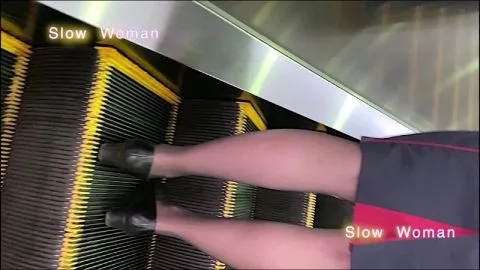 Asian teen in uniform on escalator POV