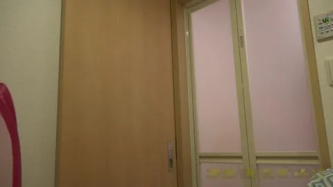 Asian Woman Undresses in Bedroom