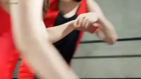 Asian Wrestlers in Red Tops Embrace