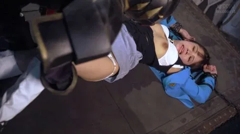 Handcuffed Woman in Blue Jacket