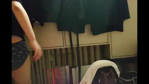 Slim Caucasian Woman Changing Clothes in Dim Bedroom