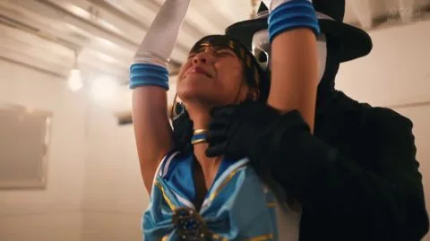 Asian woman restrained by masked men in industrial setting