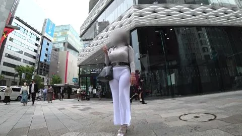 Asian Girl in Gray Sweater and White Pants