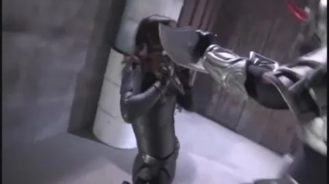 Asian Women in Metallic Suits Engage in Sword Fight
