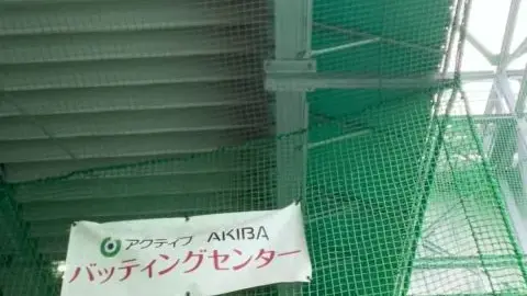 Asian Girl in Yellow Dress at Batting Cage