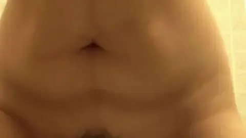 Dark-Haired Woman Bathing in Tiled Shower