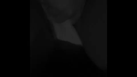 Blonde Masturbates in Dimly Lit Bedroom