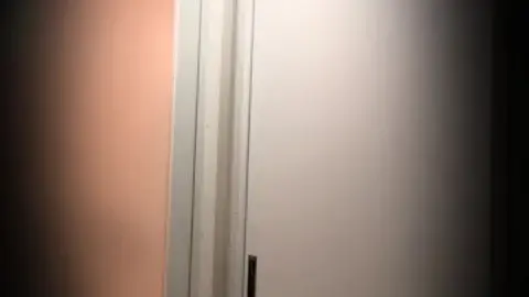 Asian Teen Undresses in Dramatic Hallway Scene