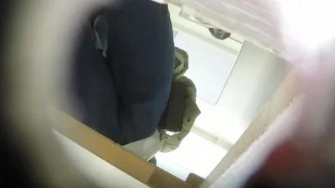 Asian Girl Adjusting Clothing on Toilet