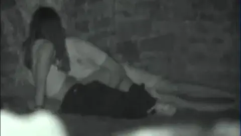 Intimate Couple’s Low-Lit Bedroom Encounter