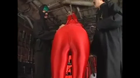 Asian Men in Red Latex Engage in Restraint and BDSM
