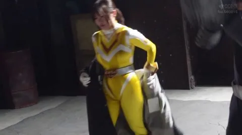 Asian Woman in Yellow Superhero Costume Fights in Dark Setting