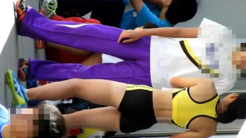 Asian Athletes Stretching and Pole Vaulting in Athletic Wear