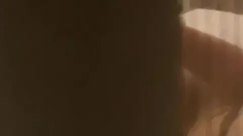 Blonde Masturbates in Dimly Lit Bedroom