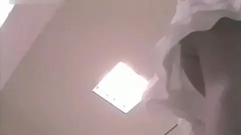 Blonde Woman Undressing in Dressing Room