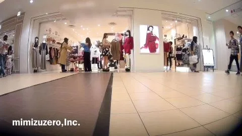 Asian girl tries on clothes in store