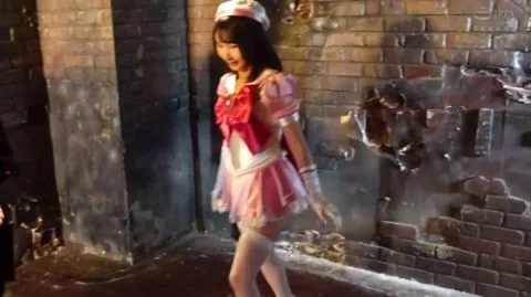 Asian nurse in industrial setting fights and poses