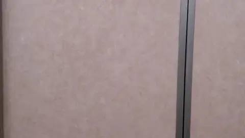 Slender Woman Exposes Thighs in Confined Space