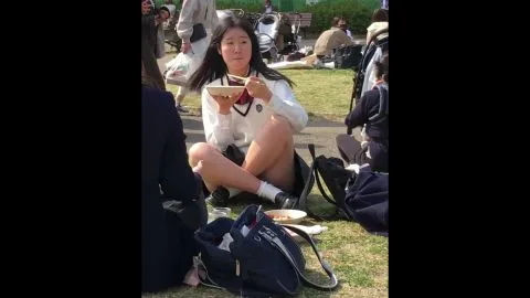 Asian Teens in School Uniforms Eating in Park