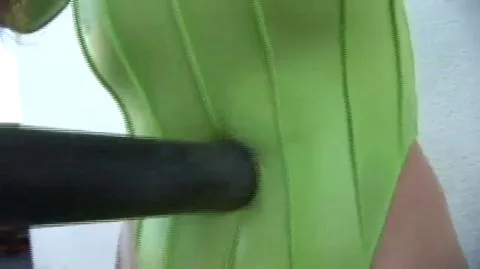 BDSM Scene with Green Corset and Restraint