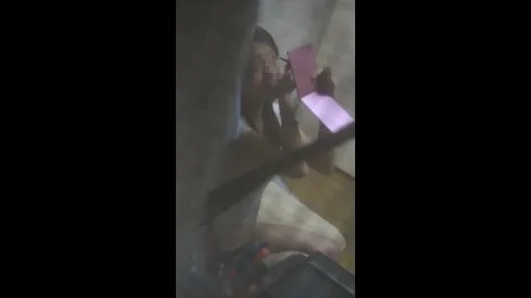 Asian Girl Sitting on Bed with Phone