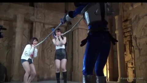 Asian Women in Futuristic Costumes Engage in BDSM