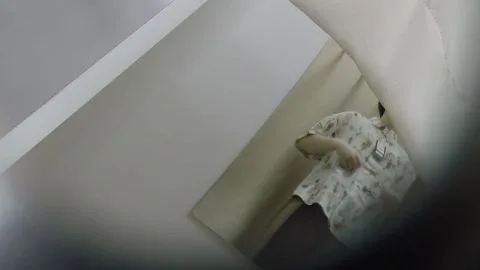 Asian girl in white floral dress undresses