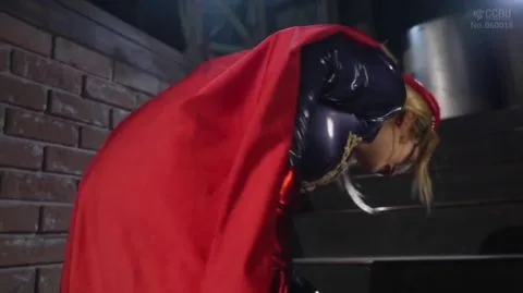 Blonde in Red Cape and Mask in Industrial Setting