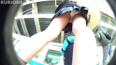 Asian girl in plaid skirt bent over in public