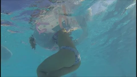 Blonde in Blue Bikini Swims Underwater