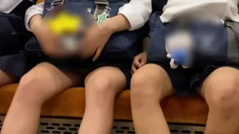 Asian Schoolgirls Resting on Train