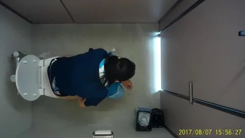 Asian Teen Sitting on Toilet