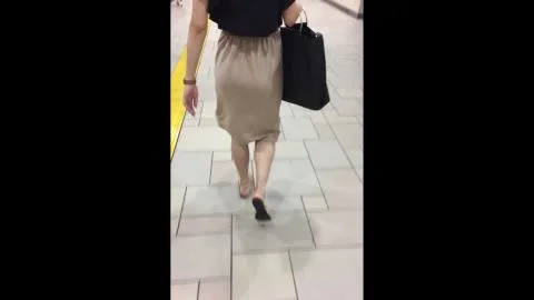 Asian Woman Walking in Public Transit
