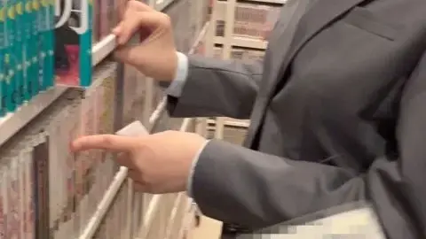 Asian Men Browse Books in Library