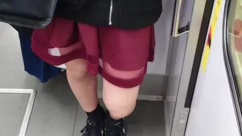 Asian girl in red skirt on subway