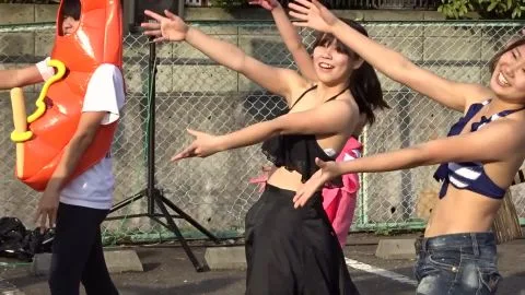 Asian Performers Dancing by the Pool