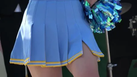 Caucasian Cheerleader Performs Outdoors