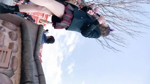 Asian Girl in Plaid Skirt and Mouse Ears at Theme Park