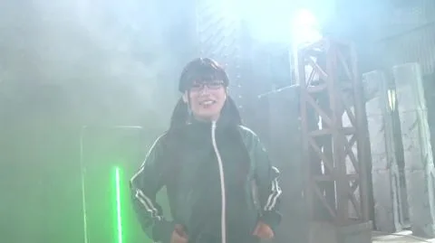 Asian Girl in Red Metallic Costume Fights in Industrial Setting