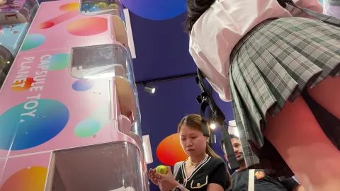 Schoolgirls in Uniform Expose Thighs at Arcade